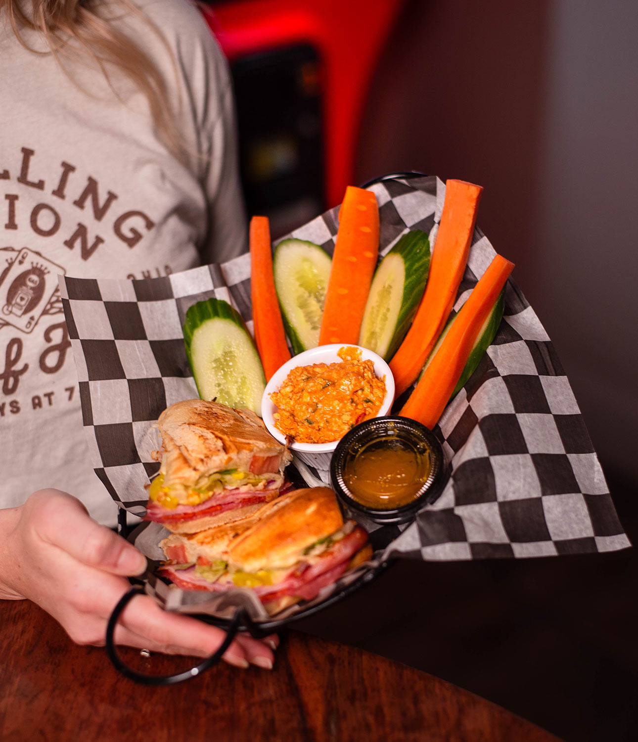 A sandwich with veggies and dip from the Filling Station